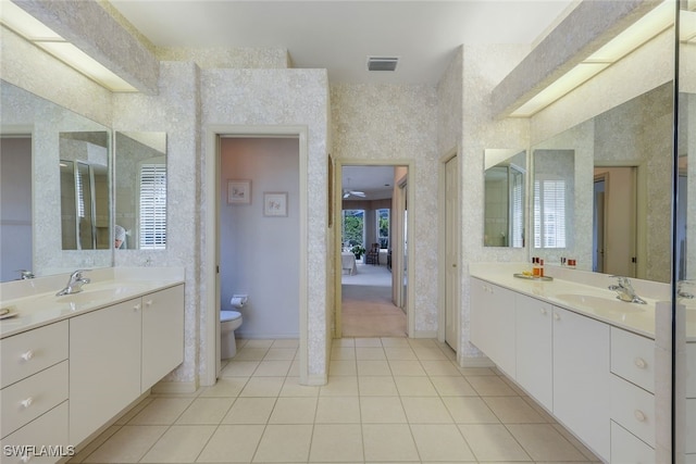 bathroom featuring tile patterned flooring, vanity, and toilet