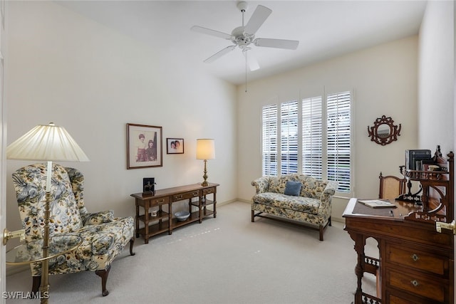 living area with carpet flooring and ceiling fan