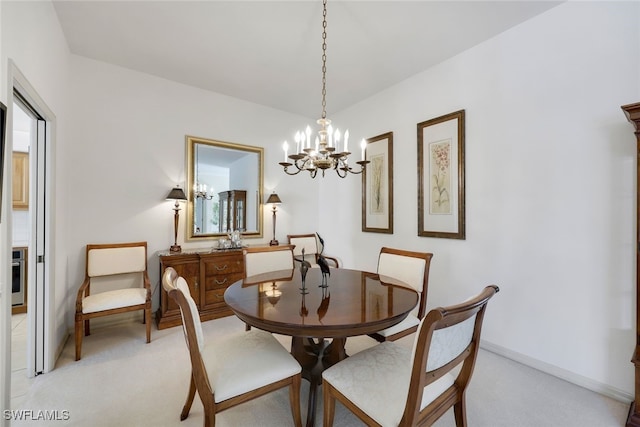 carpeted dining area with an inviting chandelier