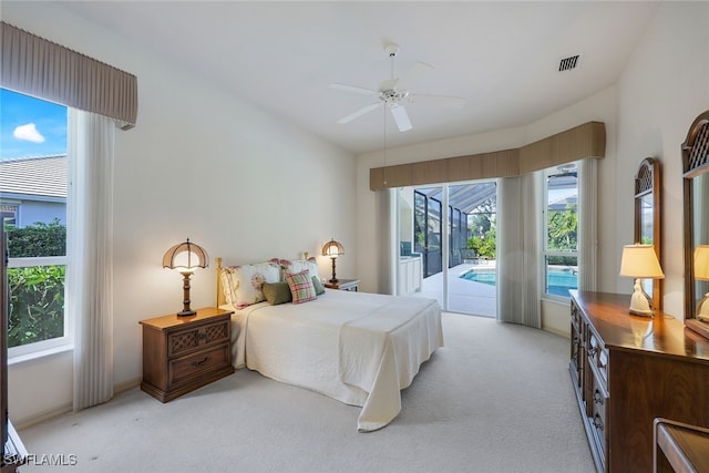 carpeted bedroom with access to outside, multiple windows, and ceiling fan