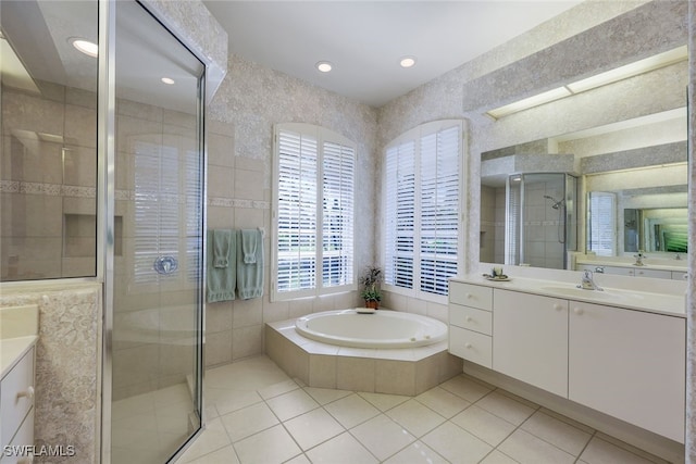 bathroom featuring tile patterned flooring, vanity, and plus walk in shower