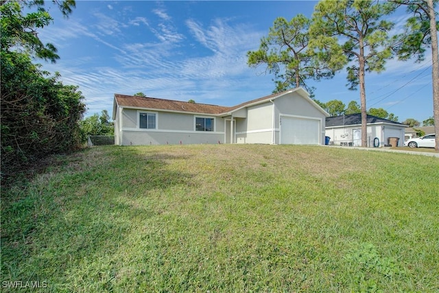 ranch-style house featuring a garage and a front lawn