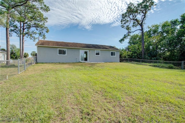 rear view of house with a lawn