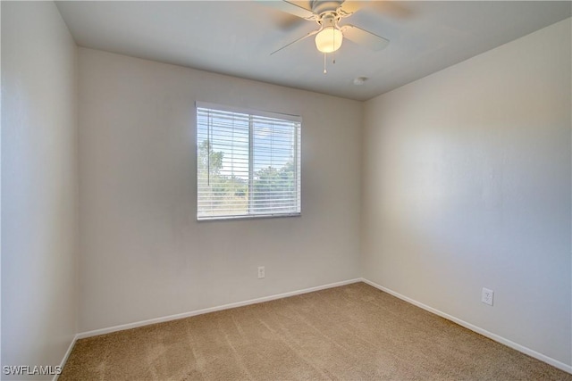 empty room featuring ceiling fan and light carpet