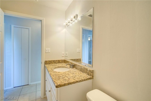 bathroom featuring vanity, toilet, and tile patterned flooring