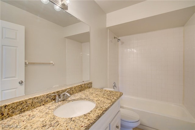 full bathroom with tiled shower / bath combo, toilet, and vanity