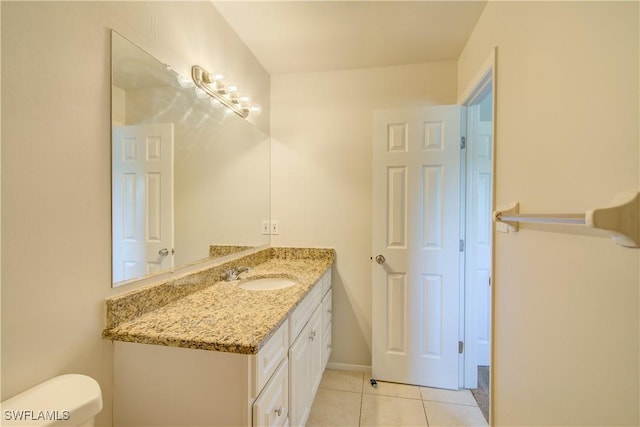 bathroom featuring vanity, toilet, and tile patterned floors