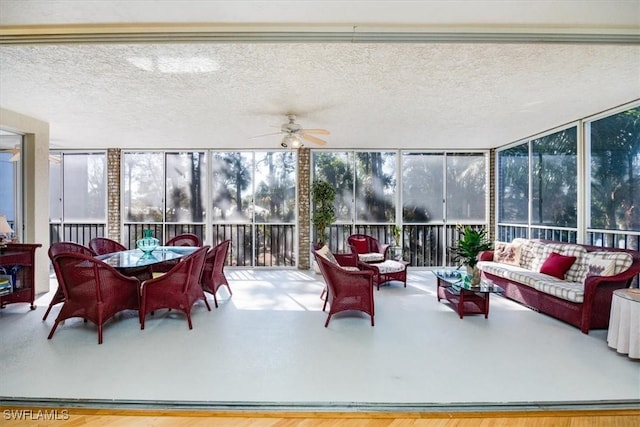 sunroom featuring ceiling fan