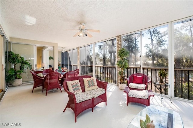 sunroom / solarium featuring ceiling fan