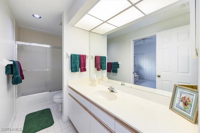 full bathroom featuring tile patterned flooring, vanity, toilet, and shower / bath combination with glass door