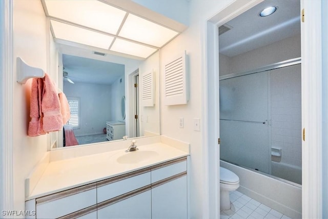 full bathroom with combined bath / shower with glass door, vanity, tile patterned floors, and toilet