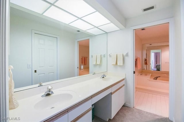 bathroom featuring tile patterned flooring and vanity