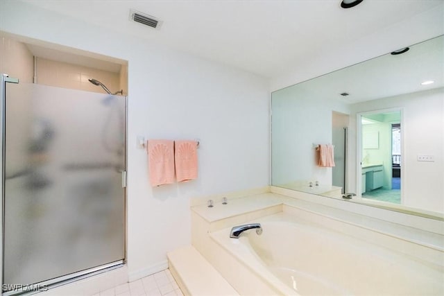 bathroom with tile patterned flooring and separate shower and tub