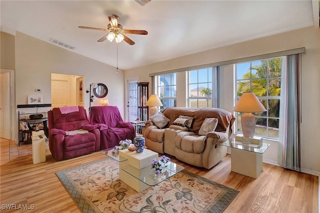 living room with ceiling fan, a wealth of natural light, and light hardwood / wood-style floors