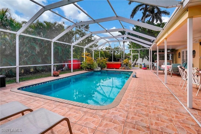 view of pool with a lanai, a patio area, and a hot tub