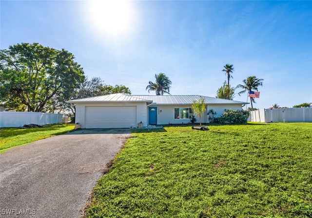 single story home with a garage and a front lawn