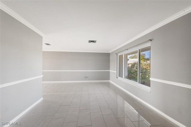 tiled spare room with ornamental molding