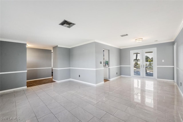 spare room with ornamental molding and french doors