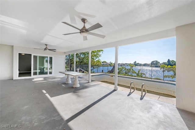 view of patio featuring ceiling fan and a water view