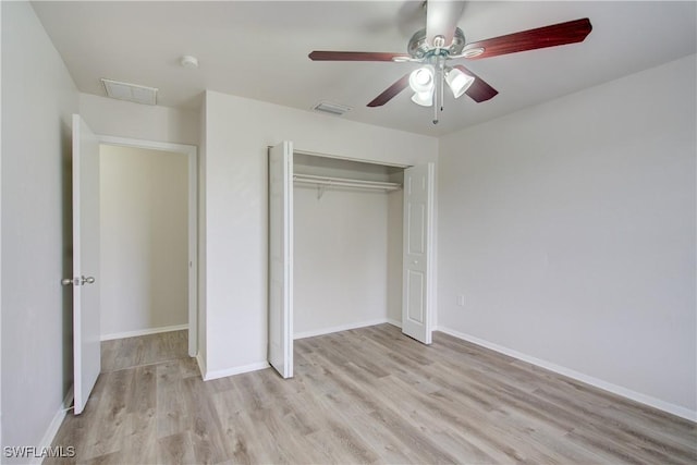 unfurnished bedroom with light wood-type flooring, a closet, and ceiling fan