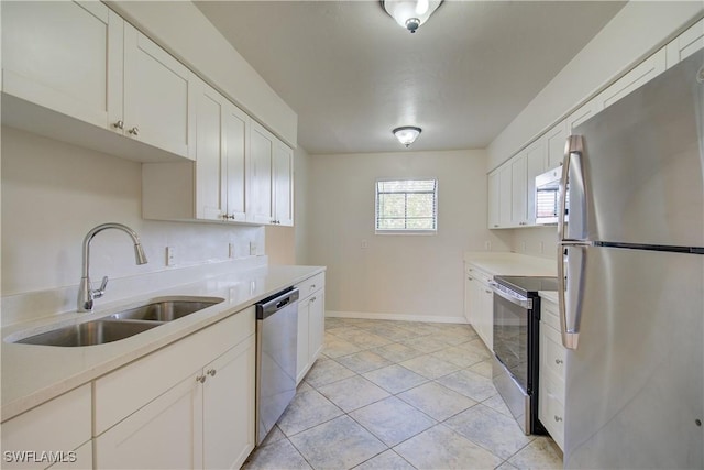 kitchen featuring sink, white cabinets, appliances with stainless steel finishes, and light tile patterned flooring