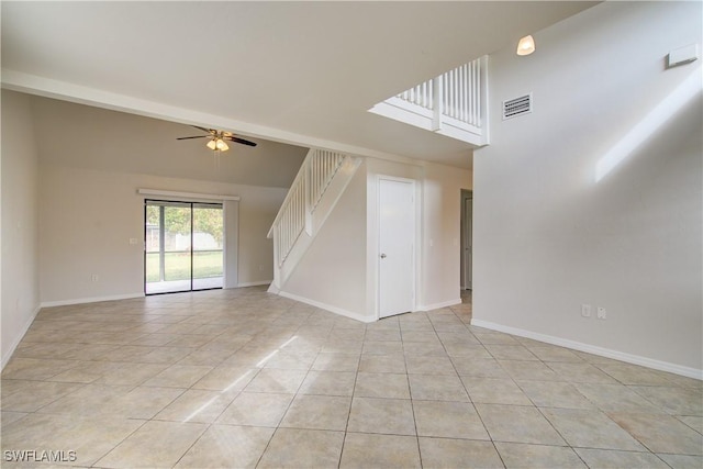 tiled spare room featuring ceiling fan