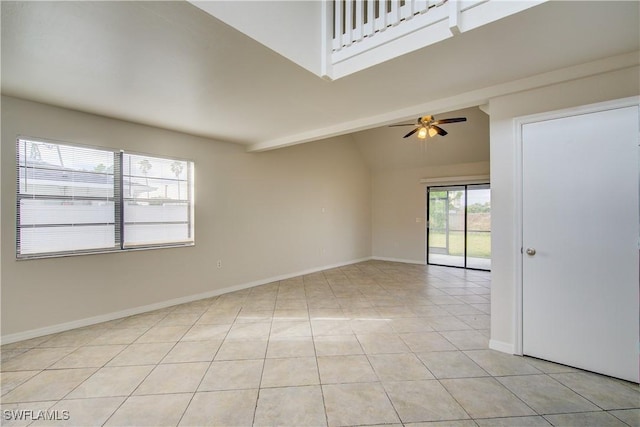 empty room featuring ceiling fan, lofted ceiling, and light tile patterned flooring