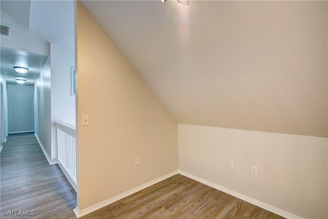 bonus room featuring wood-type flooring and vaulted ceiling