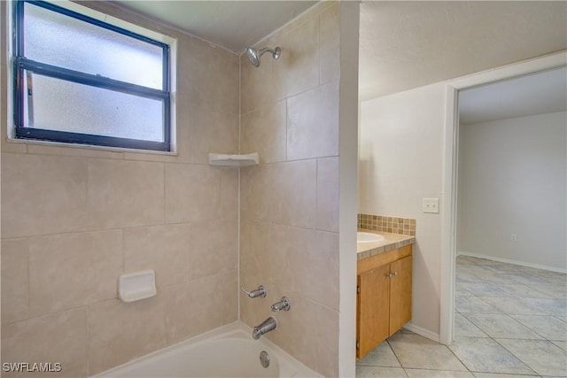 bathroom with tasteful backsplash, tiled shower / bath, tile patterned floors, and vanity