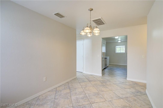 tiled empty room featuring an inviting chandelier