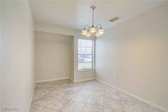 unfurnished room featuring an inviting chandelier and light tile patterned floors