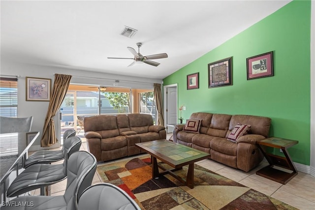 tiled living room with ceiling fan and lofted ceiling