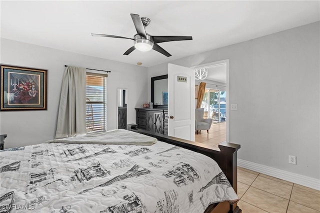 tiled bedroom with ceiling fan and multiple windows