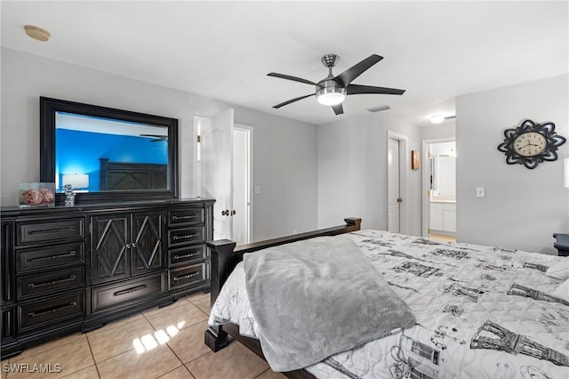 bedroom with ceiling fan, light tile patterned flooring, and ensuite bathroom