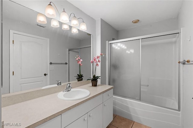 bathroom featuring tile patterned floors, vanity, and shower / bath combination with glass door