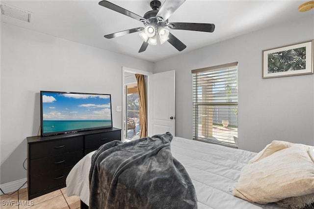 tiled bedroom featuring ceiling fan