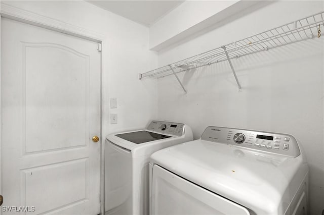 clothes washing area featuring independent washer and dryer