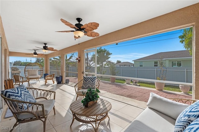 sunroom / solarium featuring ceiling fan