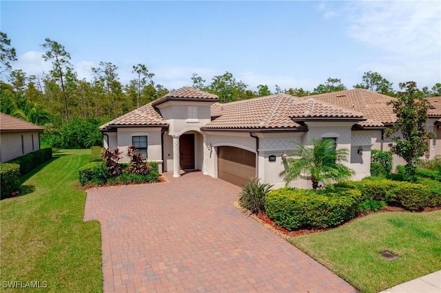 mediterranean / spanish-style house featuring a garage and a front lawn