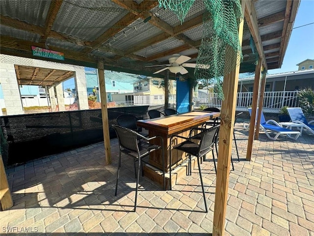 view of patio featuring ceiling fan, fence, and outdoor dining area