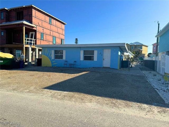 view of front of property featuring fence