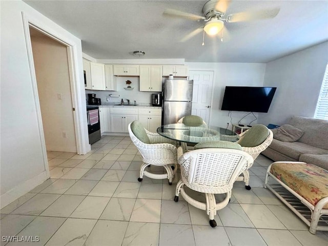 dining room featuring marble finish floor, a ceiling fan, and baseboards