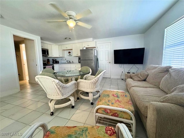 tiled living room featuring ceiling fan