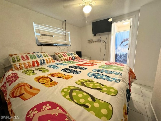 tiled bedroom featuring ceiling fan