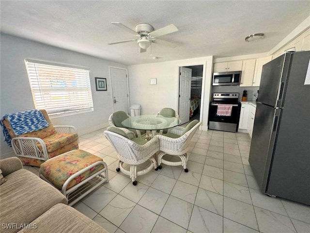 dining area featuring baseboards and a ceiling fan