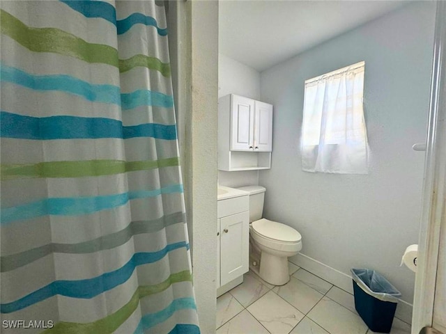 bathroom featuring toilet, vanity, and a shower with curtain