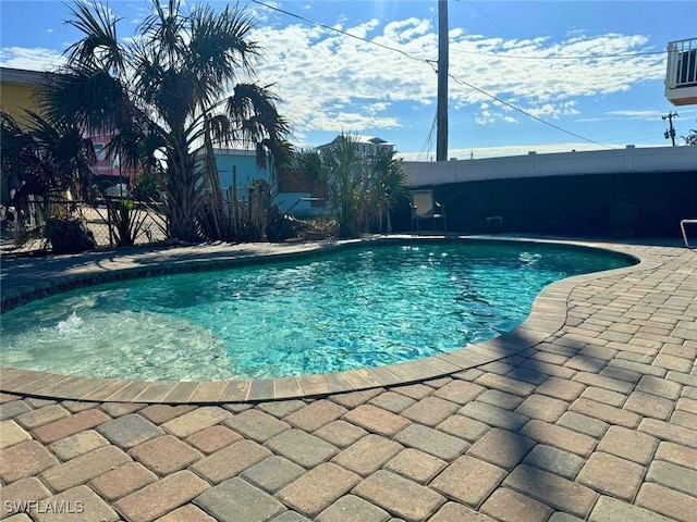 view of swimming pool featuring a patio area