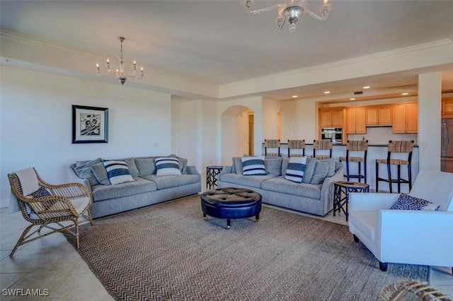 tiled living room featuring an inviting chandelier and ornamental molding