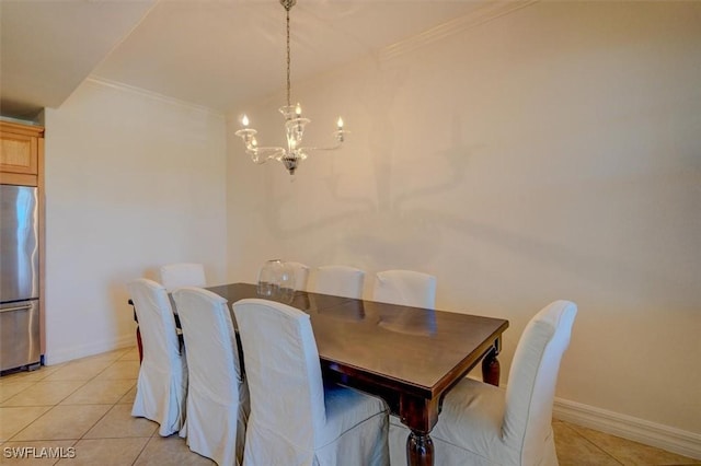 dining space with light tile patterned floors, a notable chandelier, and ornamental molding