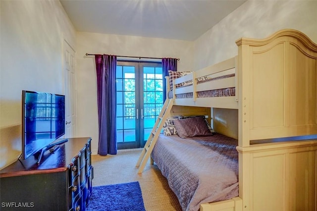 bedroom with french doors and light colored carpet